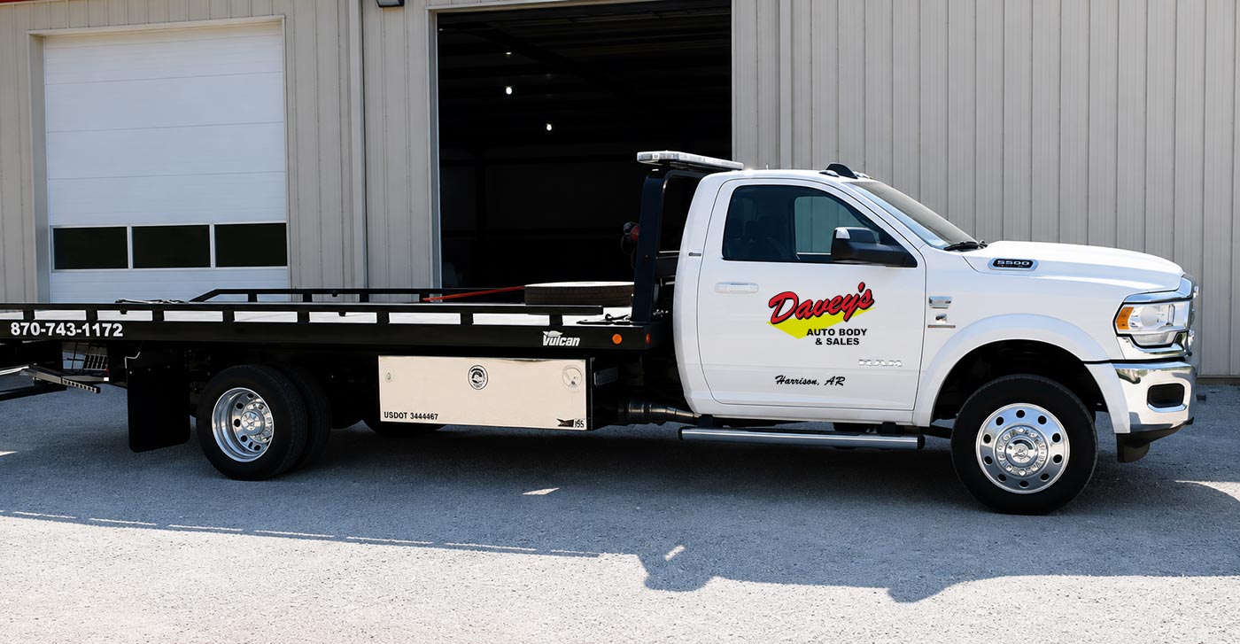 Davey's Auto Body flatbed truck outside the shop
