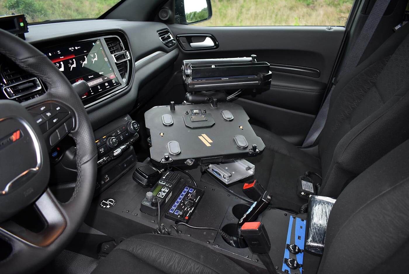 In-car computer mount and radio installed in a patrol vehicle